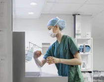 nurse with mask washing hands