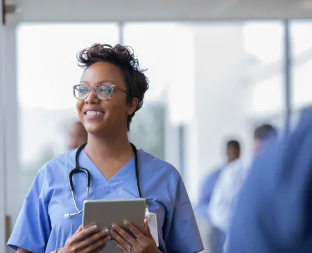 nurse holding tablet and smiling