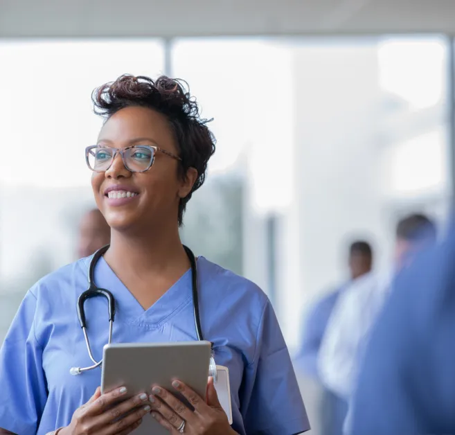 nurse holding tablet and smiling